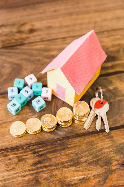 15 year vs 30 year mortgage comparison - house model with coins, keys, and calculator dice representing loan term savings